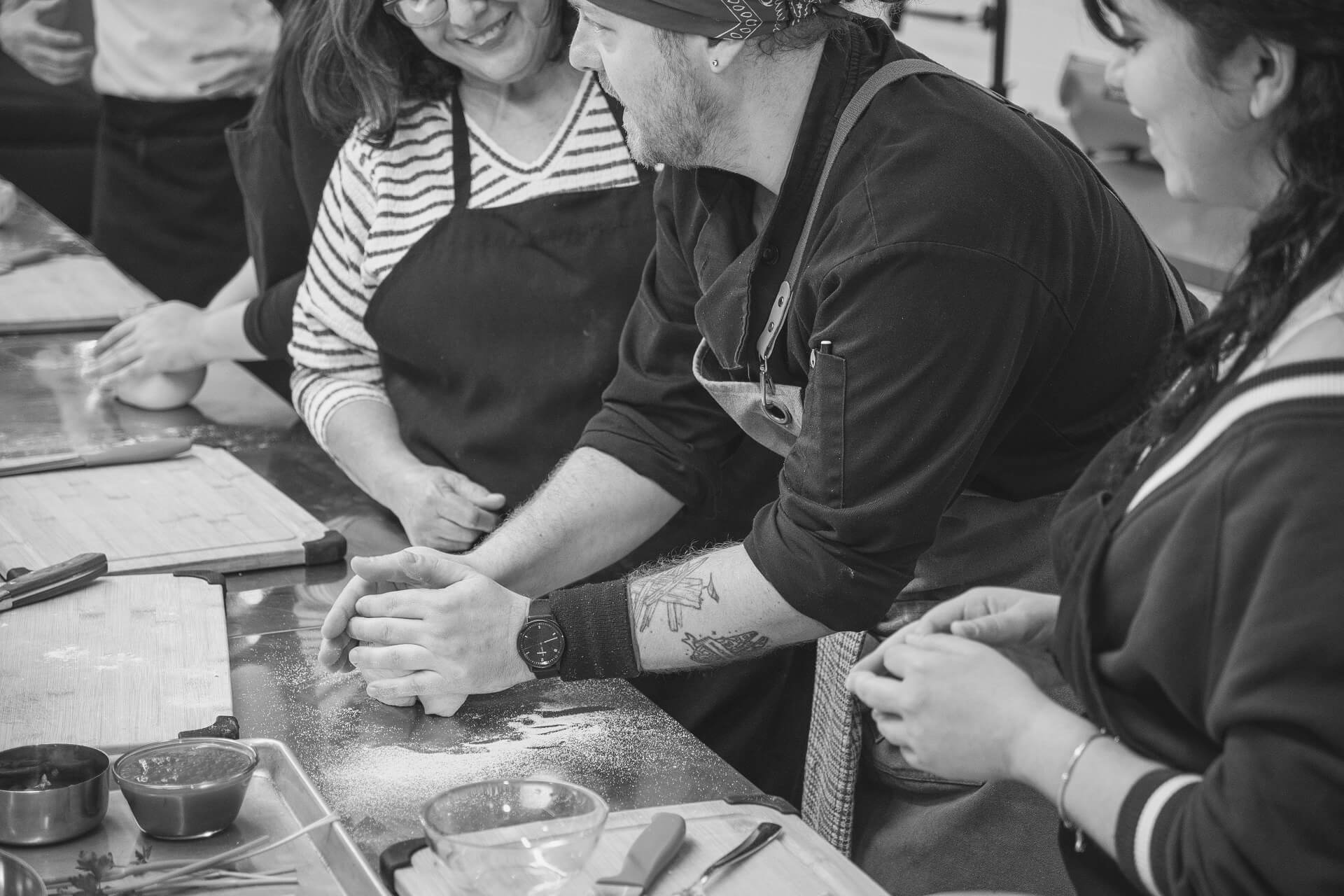 Chef showing guests how to work dough